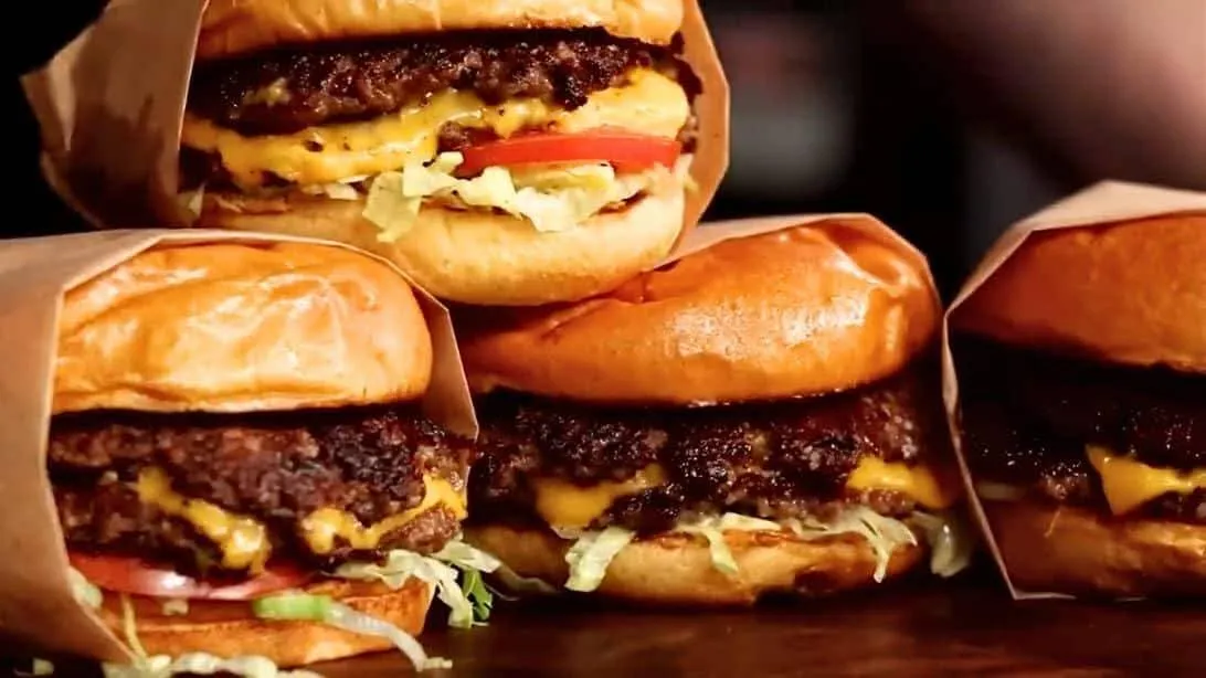A stack of BJ's cheeseburgers wrapped in paper